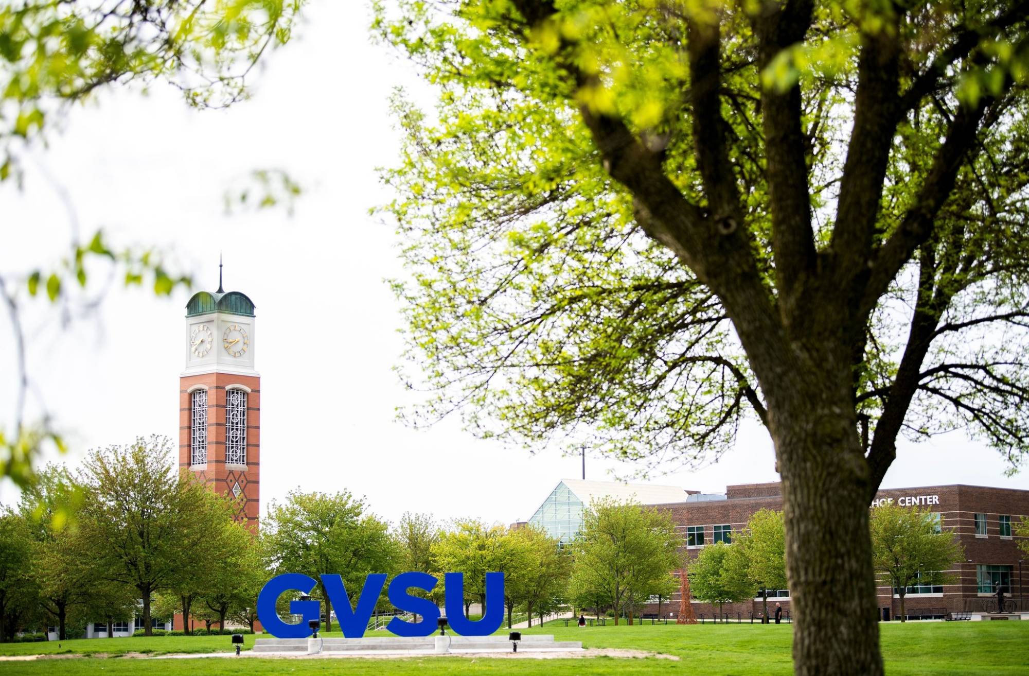 Students walking near Kirkhof Center on a sunny day